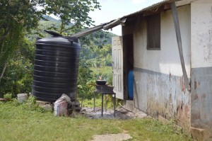A local house. Notice the pots and pans used and the source of water: rain water.