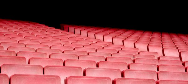 Rows of empty red theater seats