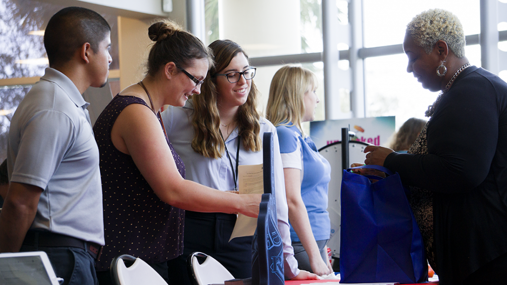 Levy Restaurants representatives talk with students at the Hospitality and Tourism Expo