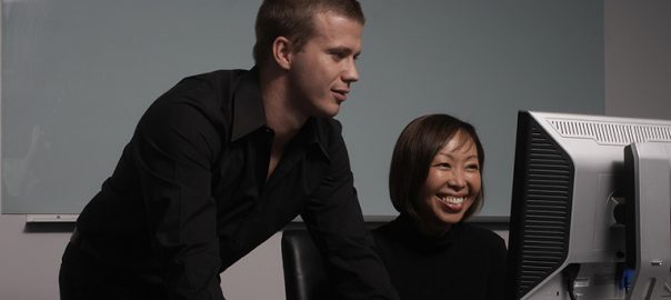 Business colleagues using computer