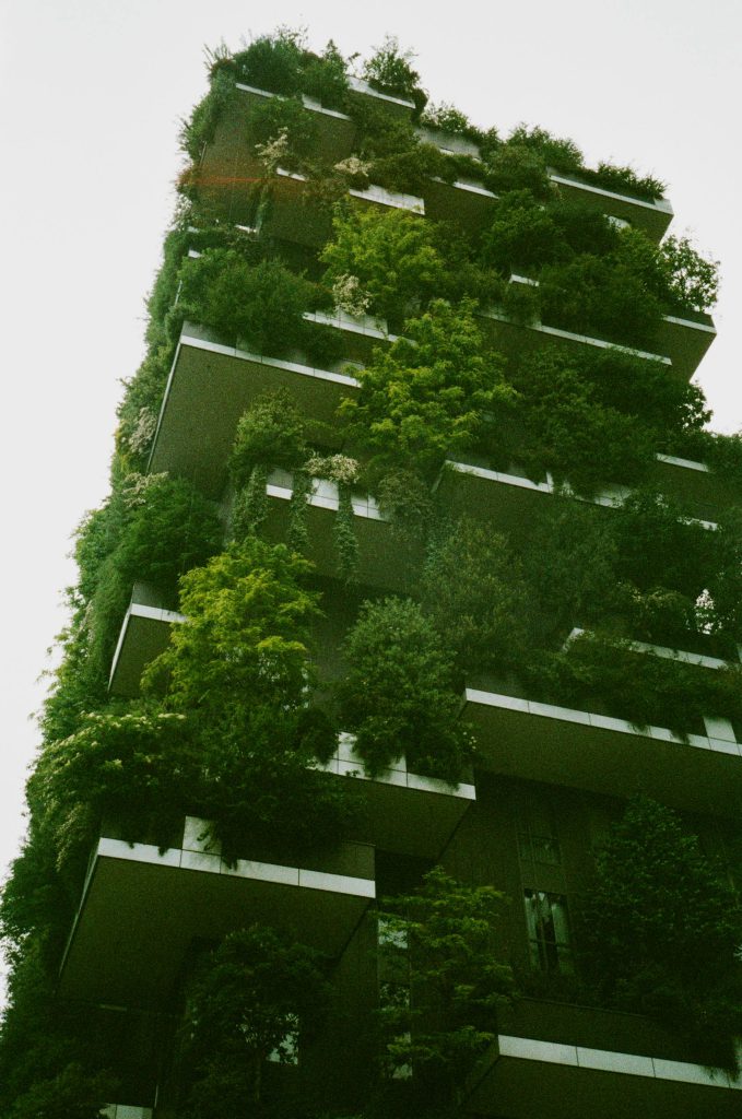 High rise building covered in lush green foliage.