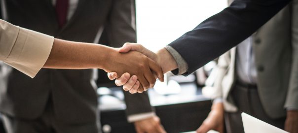 Two business people shaking hands.