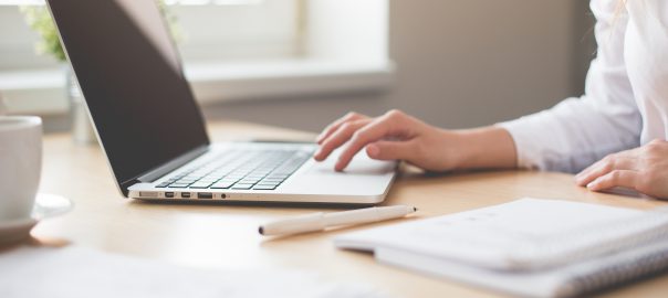 A woman working on a laptop.