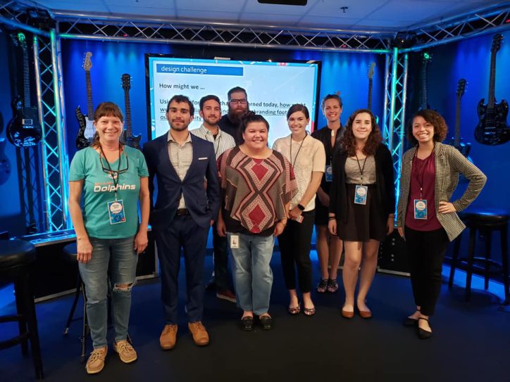 Students and staff gather on a stage in Cox Media