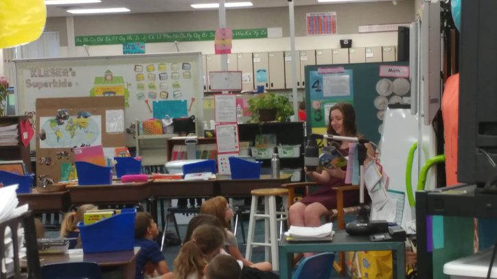 SPC Student reading to children to children