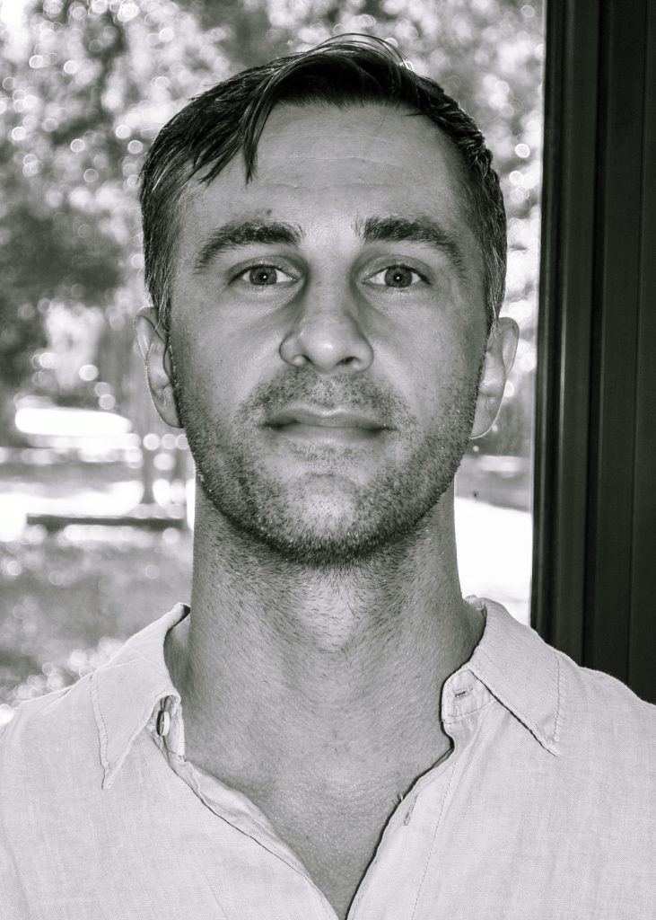 blasi faces the camera in this black and white shot
