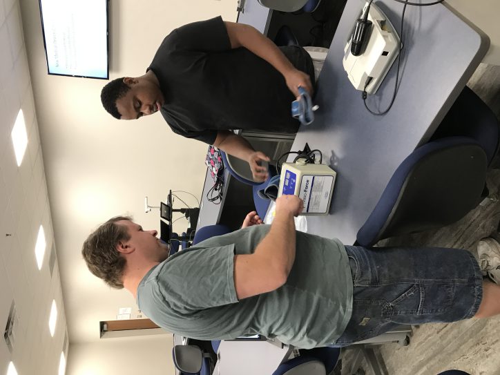 people at engineering technology open house looking at equipment