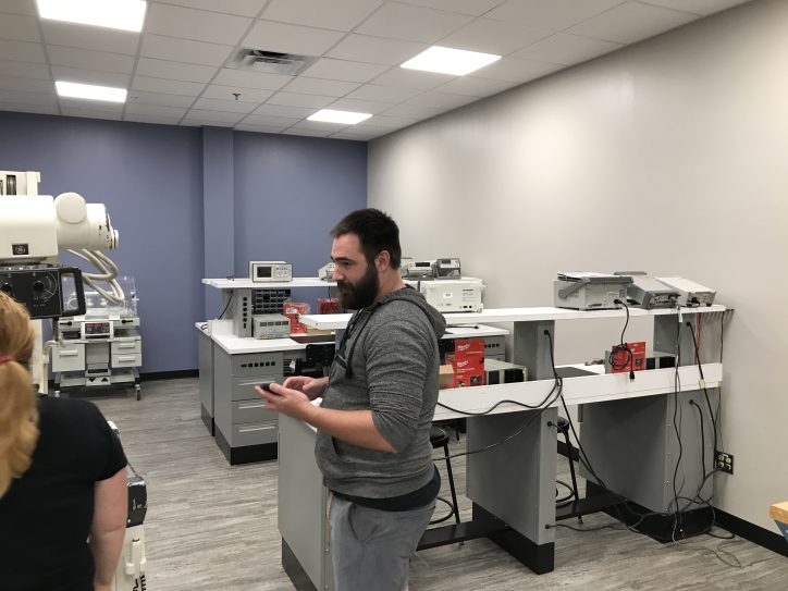 people at engineering technology open house looking at equipment
