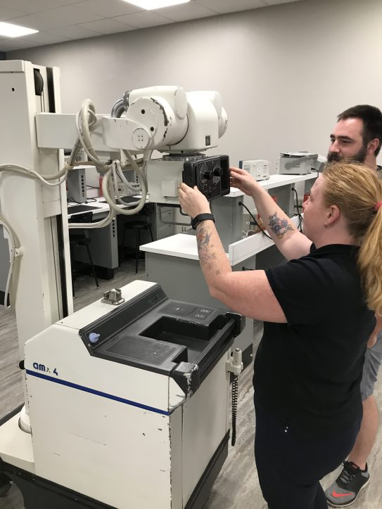 people at engineering technology open house looking at equipment