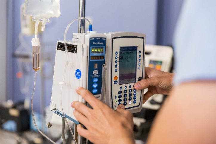 person works on IV monitor