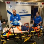 EMS Instructor Ralph Sibbio working with medic students outside the simbulance