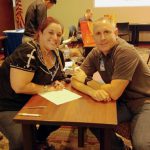 Nursing student Tiffany Bullock assists an employee at All College Day.