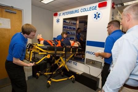 Paramedic students loading a patient into the simbulance