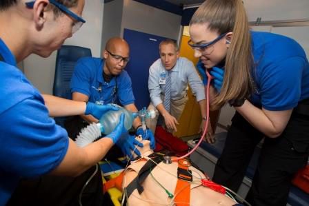 EMS Instructor Ralph Sibbio working with medic students outside the simbulance
