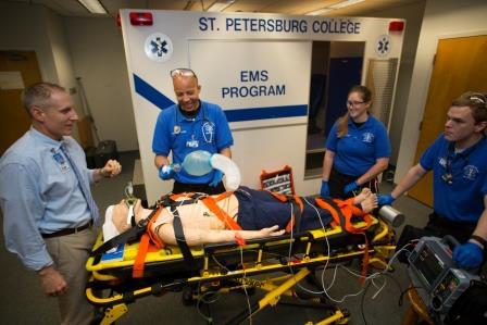 EMS Instructor Ralph Sibbio working with medic students outside the simbulance