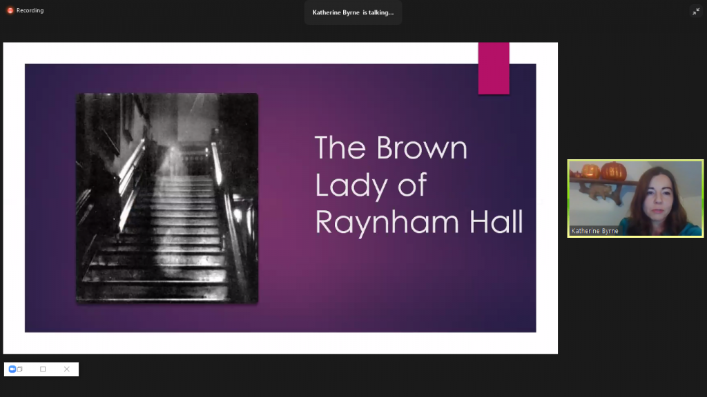 Powerpoint slide showing a spooky staircase with a ghost floating over it and the title The Brown Lady of Rayham.