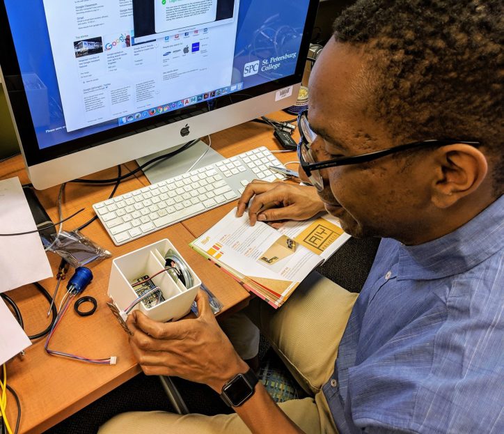 Volunteer Hambric building an AIY Voice device to experiment with natural language processing. Photo by Chad Mairn and credited to the Innovation Lab. Make, design, and create!