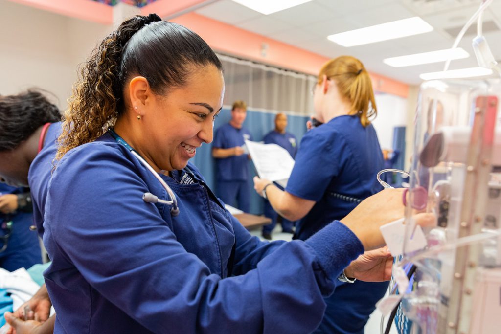 Nursing student works with equipment during a training session