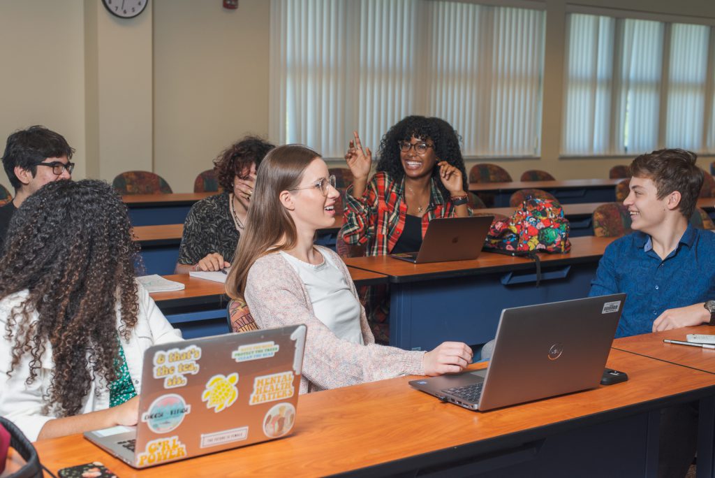 several students share a laugh in class