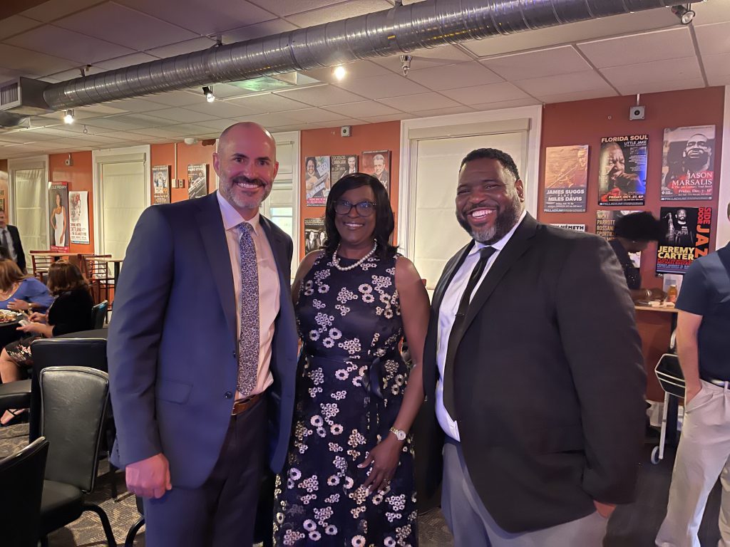 SPC President Dr. Tonjua Williams stands in the center with SPC Board of Trustees Chair Jason Butts on her left and Darryl Wright-Greene, the college's Chief Human Resources and Talent Officer, on her right.