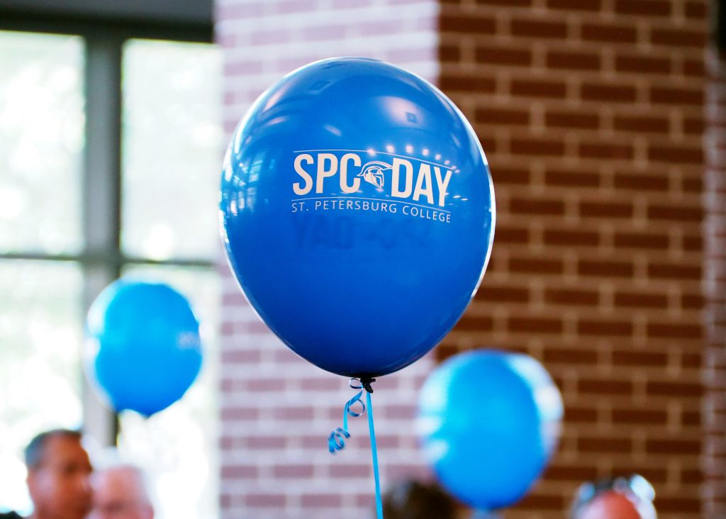 Blue latex balloon featuring the SPC Day logo.