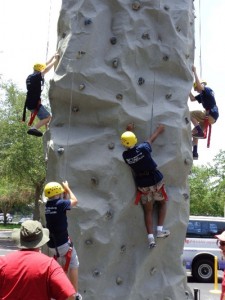 Students participate in a rock wall climbing exercise to better understand the physical challenges faced by law enforcement.