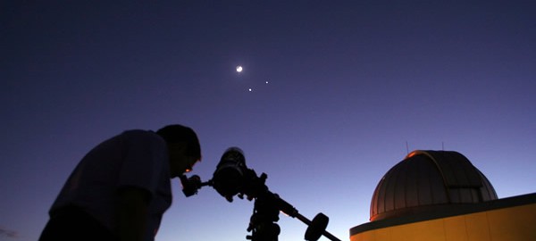 photo of man using telescope at SPG Planetarium