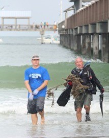Dr. Heyward Mathews works with a volunteer at a previous cleanup.