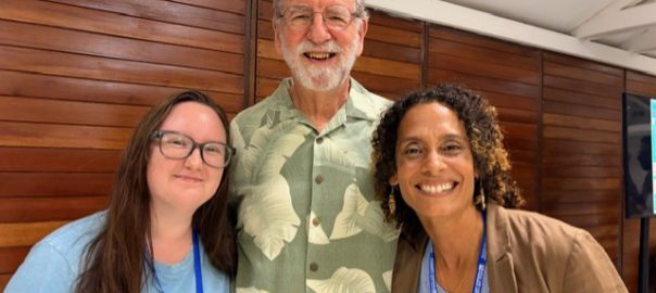 Two women and a man in the center