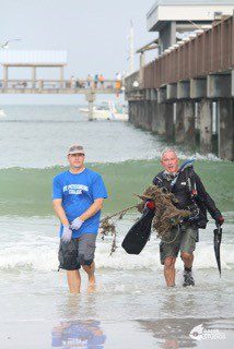 Dr. Heyward Mathews works with a volunteer at a previous cleanup.